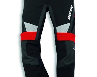 May include: Black motorcycle pants with red and gray accents. The pants feature the white "Ducati" logo on the leg. The pants have reflective panels and reinforced areas for protection. The pants are designed for motorcycle riding.