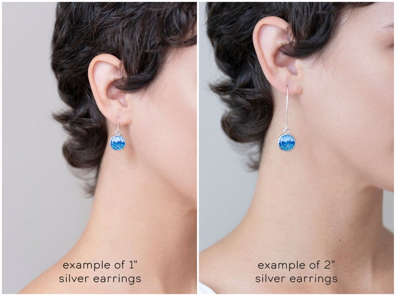 May include: Silver earrings with a round, blue design. The image shows two examples: one with 1-inch earrings and another with 2-inch earrings. The earrings have a hook closure and a bright blue, glittery interior.