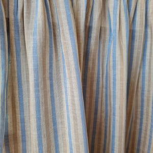 Close-up of the sky blue stripe viscose linen blend cabinet curtain showcasing the premium woven fabric, natural linen texture, fine stitching, and soft flowing drape.