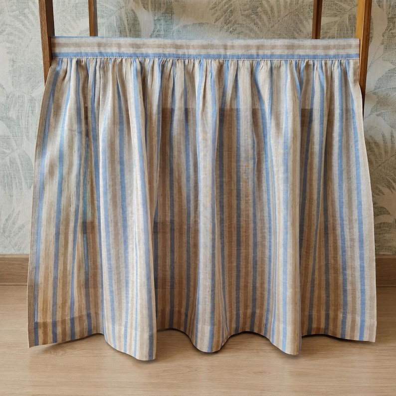Full view of the sky blue stripe viscose linen blend cabinet curtain designed for cabinets, under sink storage, shelves, or small windows.