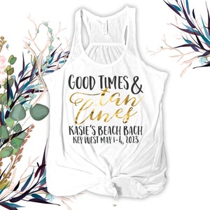 May include: White tank top with gold text that reads "Good Times & Tan Lines" and "Kasie's Beach Bach Key West May 1-4, 2023".