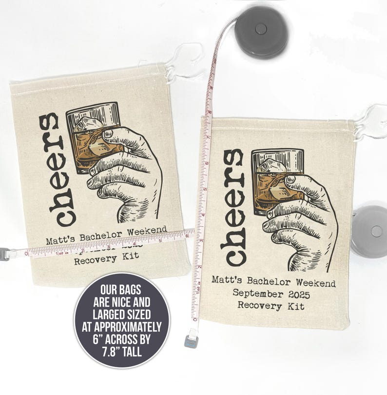 May include: Two beige canvas bags with drawstring closures. Each bag features a black and white illustration of a hand holding a glass of whiskey with ice. The text "cheers" is printed vertically on the bag. The text "Matt's Bachelor Weekend" and "Recovery Kit" is printed on the bottom of each bag. The bags are approximately 6 inches wide and 7.8 inches tall.