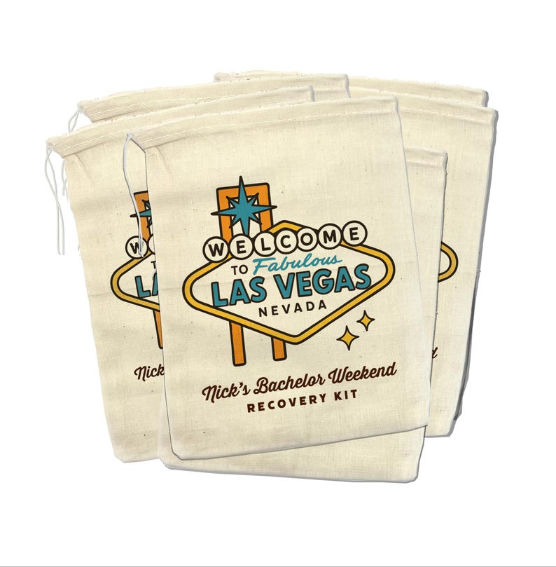 May include: Set of five beige canvas bags with a drawstring closure. Each bag features a graphic of the Las Vegas sign with the text "Welcome to Fabulous Las Vegas, Nevada". The bags also have the text "Nick's Bachelor Weekend Recovery Kit".
