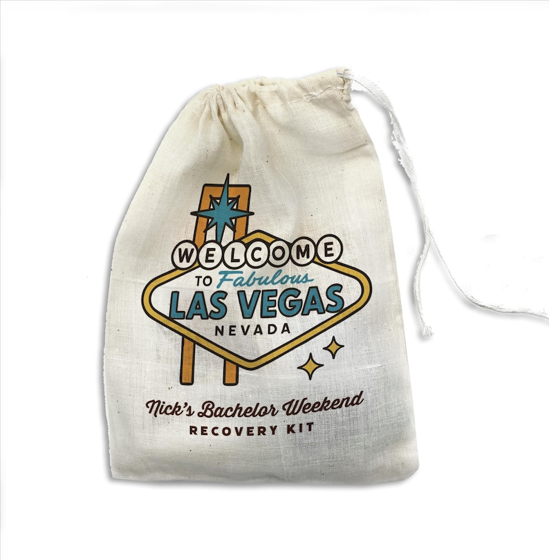 May include: A white cotton drawstring bag with a printed design of the Las Vegas sign that says "Welcome to Fabulous Las Vegas, Nevada". The bag also says "Nick's Bachelor Weekend Recovery Kit".