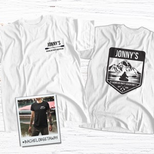 May include: Two white t-shirts with a black graphic design. The first shirt has the text "Jonny's Bachelor Party Adventure" and a paddle. The second shirt has the text "Jonny's Bachelor Party Adventure" and a mountain scene with a person kayaking. The text "Sept 2020" is also on the second shirt. The hashtag #bachelorgetaway is below the shirts.