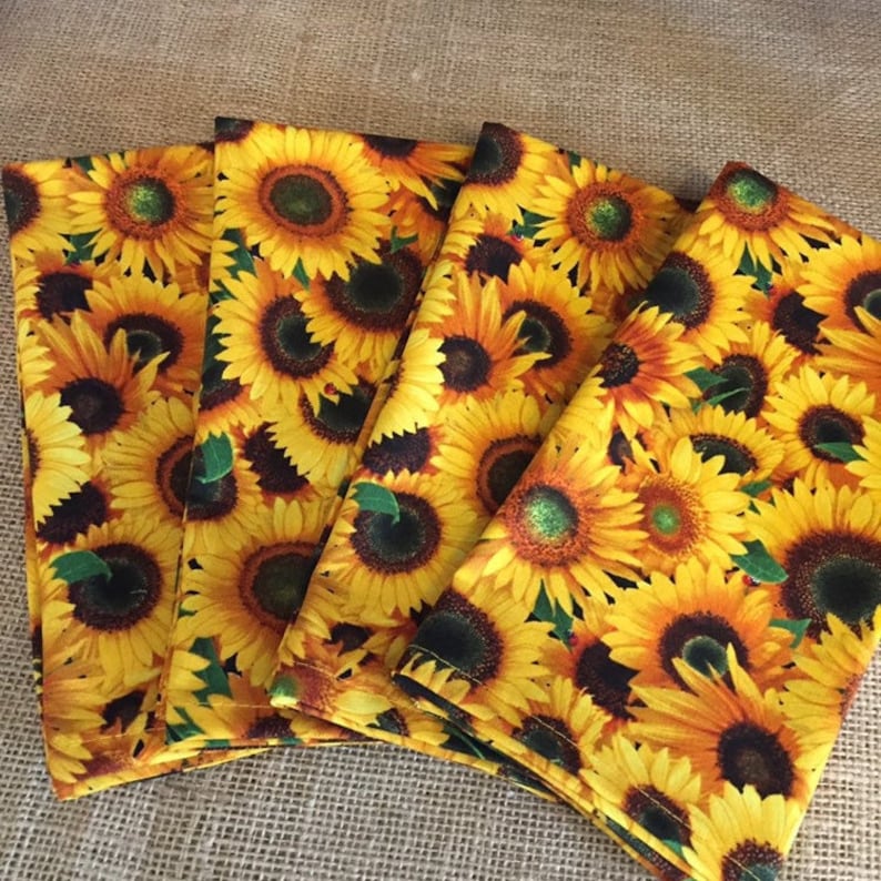 Sunflower cloth napkins in gold and brown with little lady bugs.