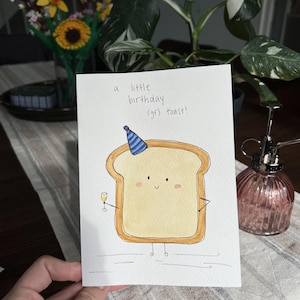 May include: A set of three ceramic mugs with a speckled, matte finish. The mugs are in shades of cream, light gray, and dark gray. Each mug has a simple, minimalist design and a rounded handle.