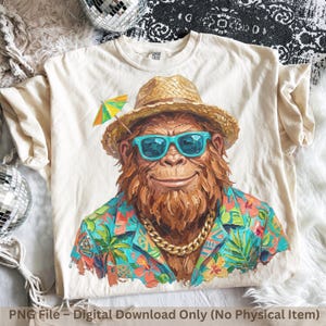 May include: A cream-colored t-shirt featuring a graphic of a brown, furry creature wearing a straw hat, bright turquoise sunglasses, and a gold chain. The creature wears a colorful tropical shirt with palm trees and flowers, and a cocktail umbrella.