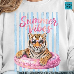 May include: White sweatshirt with a graphic of a tiger wearing sunglasses and a pink inner tube. The words "Summer Vibes" are written in pink script above the tiger, with blue vertical stripes in the background.