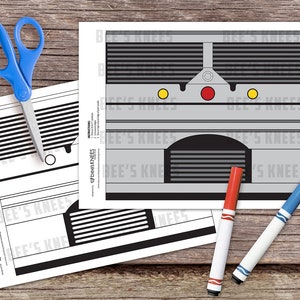May include: A printable craft template for a train, featuring a black and white design with the text "beesKNEES" repeated throughout. The template is designed to be cut out and assembled into a 3D model.