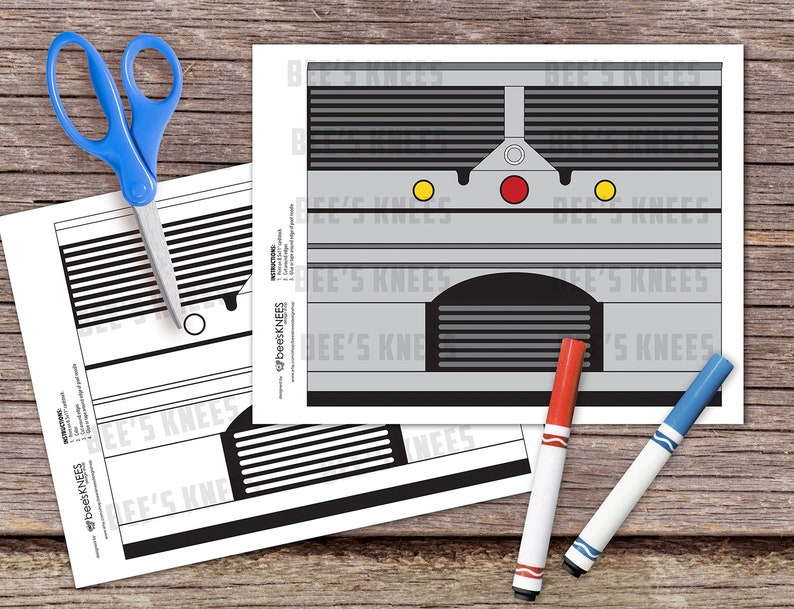 May include: A printable craft template for a train, featuring a black and white design with the text "beesKNEES" repeated throughout. The template is designed to be cut out and assembled into a 3D model.