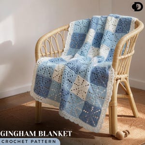 May include: A handmade gingham blanket in shades of blue and white, draped over a wicker chair. The blanket features a square pattern with a scalloped edge. The text "GINGHAM BLANKET CROCHET PATTERN" is displayed at the bottom of the image.