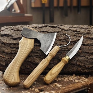 May include: A collection of woodworking tools, including a small axe, a curved knife, and a straight-blade knife, resting on a textured wooden log. The tools have light-colored wooden handles and silver blades. Sawdust is scattered around the tools.