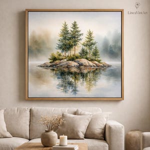 May include: A square framed wall art print featuring a watercolor painting of a small rocky island with evergreen trees in the center of a calm lake. The scene is surrounded by a soft, misty atmosphere with muted green, blue, and beige tones.