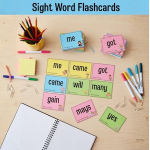 May include: A collection of colorful sight word flashcards with words like "me," "came," and "got." The cards are arranged on a wooden surface alongside pens, pencils, and a notepad. The text "Sight Word Flashcards" is at the top.