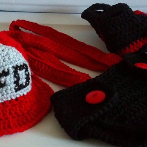 May include: A crocheted firefighter hat with a white 'FD' patch, a pair of red crocheted booties, and a black crocheted diaper cover with red buttons.
