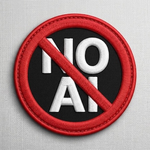 May include: Embroidered patch with a black center and a red border. The words "NO AI" are embroidered in white, with a red diagonal line through the text, indicating a prohibition. The patch is circular.