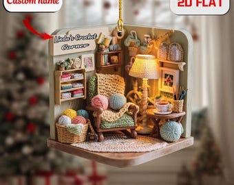 May include: A 2D flat ornament depicting a cozy crochet corner. The scene includes a chair with yarn balls, a lamp, a basket of yarn, and a small table with a teacup. The ornament has the text "Linda's Crochet Corner" and "Custom name".