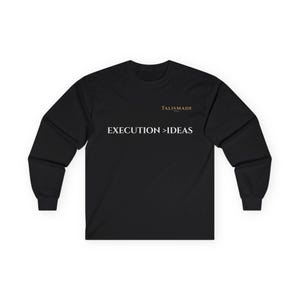 May include: Black long-sleeve shirt with the text "EXECUTION > IDEAS" in white. The brand name "TALISMADE" is printed in gold above the text. The shirt is made of a soft, comfortable material.