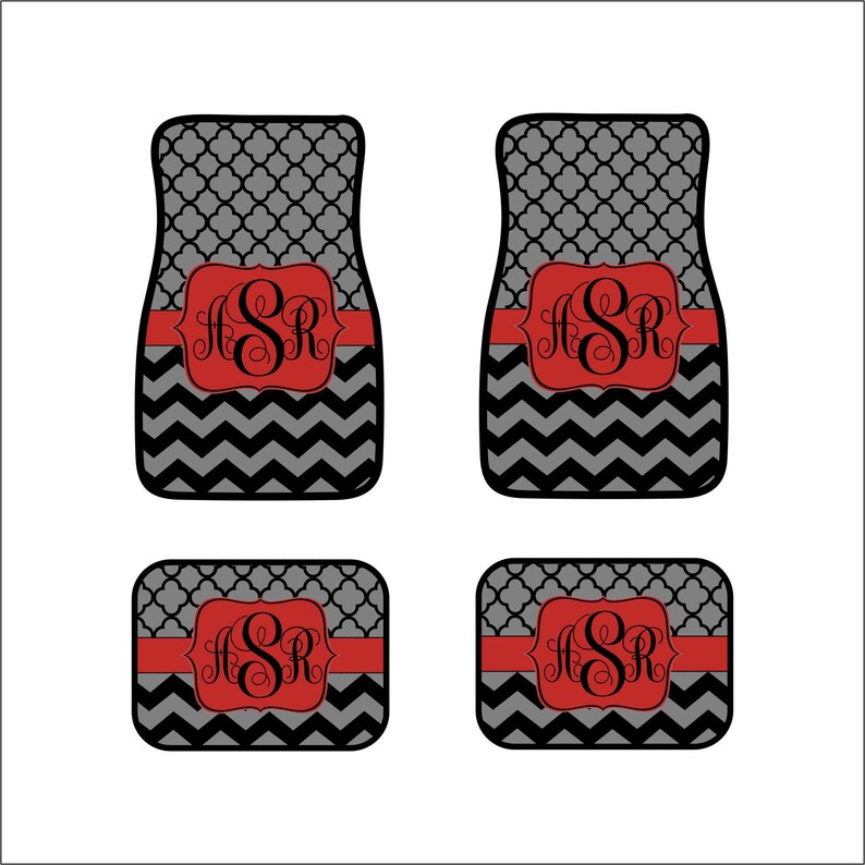 May include: Set of four black and gray car floor mats with a red chevron pattern and a red monogram "ASR" in the center.