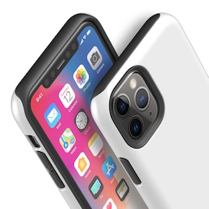 May include: A white phone case with a black bumper and a clear back. The phone case has a raised camera bump with three lenses. The phone case is shown on a white iPhone with a black screen.