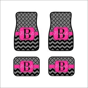 May include: Set of four black and gray car floor mats with a pink chevron pattern and the name "Brandi" in a pink banner.