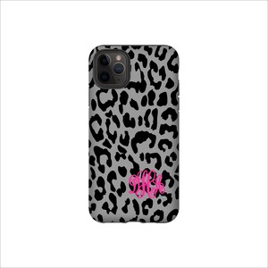 May include: A grey and black leopard print phone case with a pink monogram "BHK".