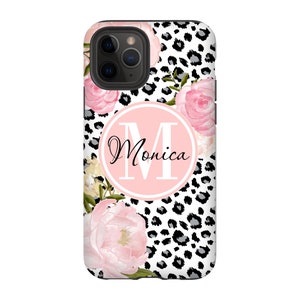 May include: A black and white leopard print phone case with pink flowers and a pink circle with the letter "M" and the name "Monica" in black text.