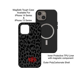 May include: Black phone case with a leopard print design and a red monogram. The case is compatible with iPhone 13 and 14 series and has a built-in MagSafe ring.