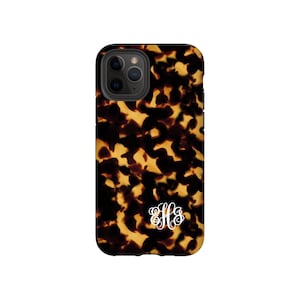 May include: A black phone case with a tortoiseshell pattern and a white monogram. The monogram is the letters "HFS" in a script font.