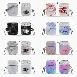 May include: Eight different Airpod cases with various marble patterns. The cases are white, black, red, blue, pink, purple, and gold. Some cases have a monogram, while others have the name "Lindsay" printed on them.
