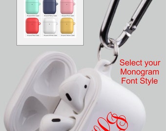 May include: White Airpod case with a red monogram and a silver carabiner clip. The case is available in nine colors, including black, blue, grey, mint, navy, pink, red, white, and yellow.