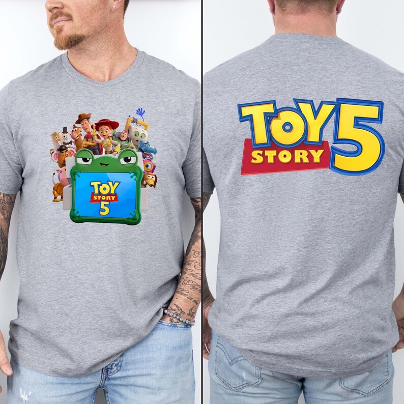 May include: A heather grey t-shirt featuring a front graphic of Toy Story characters surrounding a green frog-shaped frame with the text Toy Story 5, and a back graphic displaying the large blue and yellow text Toy Story 5 on a red background.