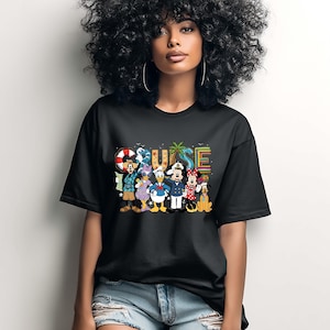 May include: Black t-shirt featuring the word "CRUISE" in colorful letters with a palm tree graphic. The shirt also displays cartoon characters including Mickey Mouse, Minnie Mouse, Donald Duck, and Goofy. The shirt is worn by a person.