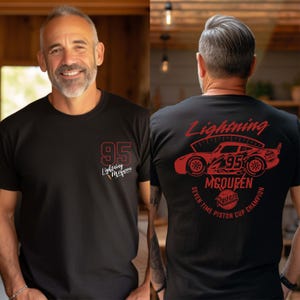 May include: Black t-shirt with Lightning McQueen graphics. The front has "95" and "Lightning McQueen" in red. The back features a red car design with "Lightning McQueen," "95," and "Seven Time Piston Cup Champion" text.