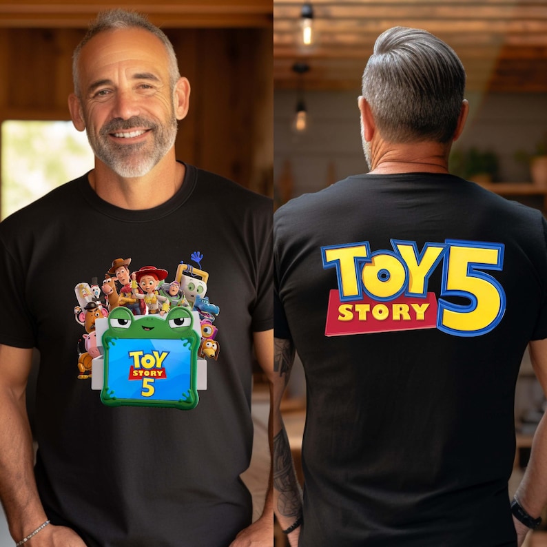 May include: A black t-shirt featuring a graphic of Toy Story characters behind a green frog-shaped frame with the text Toy Story 5 on the front, and the large blue and yellow text Toy Story 5 printed on the back of the shirt.