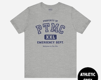 May include: An athletic grey short-sleeve t-shirt featuring dark blue text that reads PROPERTY OF PTMC, XXL, EMERGENCY DEPT., and Welcome to The Pitt. The shirt has a crew neckline and a standard fit, with a small brand logo printed at the inner neck.