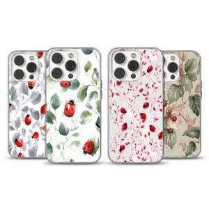 May include: Four phone cases with different floral and ladybug designs. The cases feature a clear border and a variety of backgrounds, including gray, white, and beige. The ladybugs are red and black.