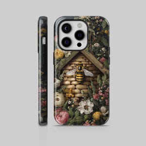 May include: A phone case featuring a detailed illustration of a bee and its hive, surrounded by flowers and foliage. The case has a dark background with a floral pattern on the side.