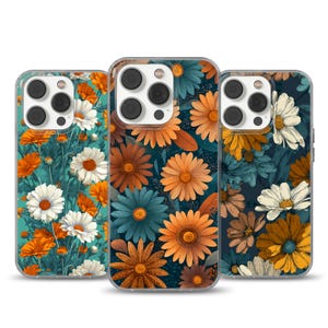 May include: Three phone cases with floral designs. The cases feature a variety of colorful flowers, including orange, white, and teal daisies, set against a dark background. The cases have a clear border and a camera cutout.