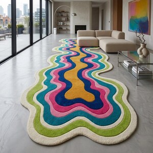 Colorful wavy abstract area rug featuring layered organic curves in green, turquoise, pink, navy blue, mustard yellow, and ivory. Plush raised tufted texture and sculptural irregular shape create a bold modern statement. Shown in a luxury hallway and on a neutral floor, this colorful area rug is ideal for living rooms, bedrooms, hallways, studios, offices, and contemporary interiors.