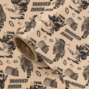 May include: Roll of brown wrapping paper with a repeating pattern of cartoon raccoons, trash cans, bottles, and the words "Trashed Panda." The raccoons are depicted in various poses, some sleeping, others near trash.