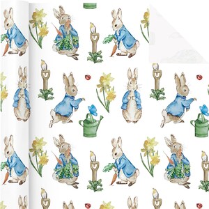 May include: White wrapping paper with a repeating pattern of Peter Rabbit illustrations. The design features rabbits in blue jackets, carrots, daffodils, watering cans, and birds. The overall color palette is soft and pastel.