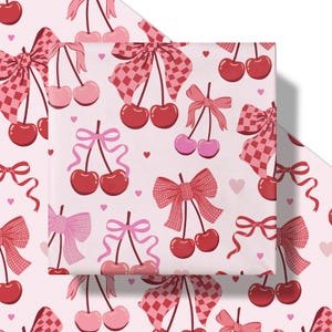 May include: Wrapping paper with a repeating pattern of cherries and bows in shades of red and pink. The bows have a gingham and ribbon design. Small pink hearts are scattered across the light pink background.