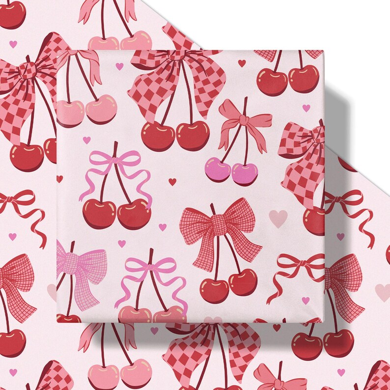 May include: Wrapping paper with a repeating pattern of cherries and bows in shades of red and pink. The bows have a gingham and ribbon design. Small pink hearts are scattered across the light pink background.
