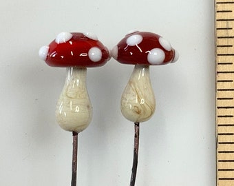 Glass mushroom Pair made on 20 gauge copper wire.  fly agaric mushroom