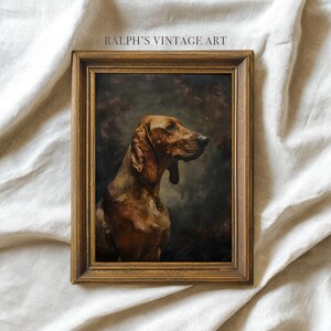 Peut inclure: Peinture vintage encadrée d'un chien brun aux longues oreilles, sur fond sombre et sombre. L'œuvre est dans un cadre en bois doré. Le texte "RALPH'S VINTAGE ART" est en haut du cadre.