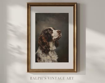 Puede incluir: Retrato vintage enmarcado de un perro. La obra presenta un perro marrón y blanco con la mirada hacia arriba, sobre un fondo oscuro. El marco es dorado y el texto "RALPH'S VINTAGE ART" es visible en la parte inferior.