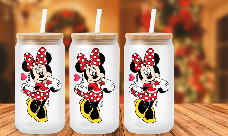 May include: A white ceramic mug with a black handle and the text "But First, Coffee" in a bold, black font. The mug is set against a blurred background, suggesting a cozy setting.