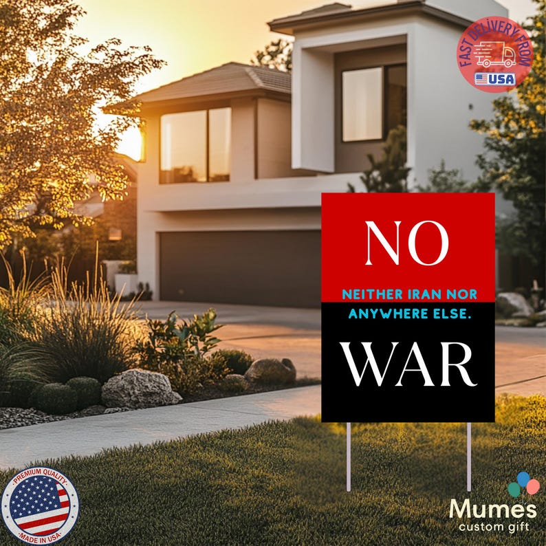 May include: A yard sign with the word "NO" in white on a red background, and "WAR" in white on a black background. The text "NEITHER IRAN NOR ANYWHERE ELSE" is between the two. The sign is in front of a house.